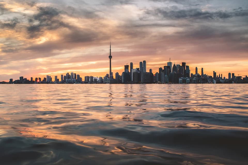 The Toronto skyline and CN Tower across Lake Ontario at golden hour